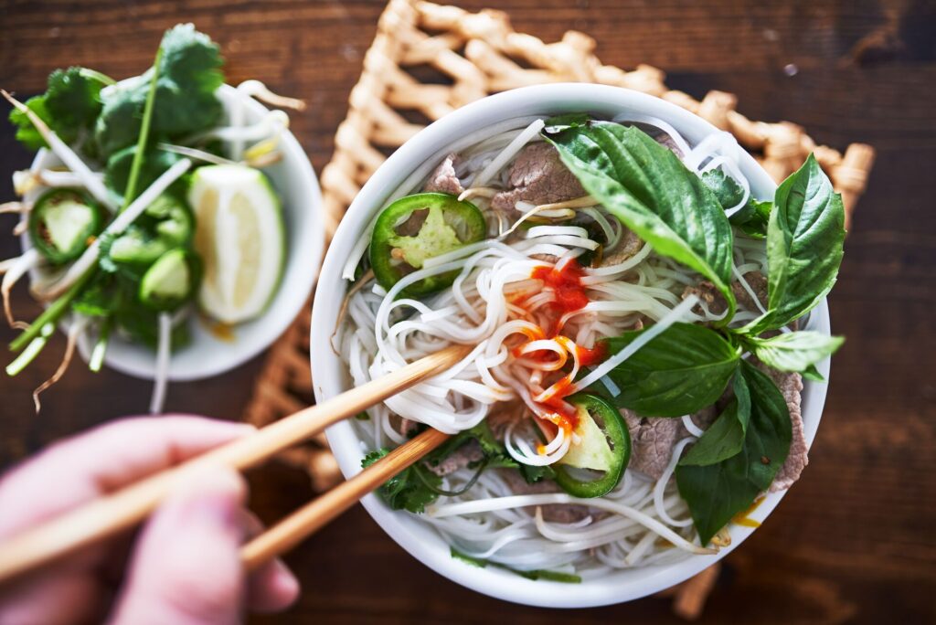 vietnamese pho with spicy sriracha sauce shot top down 