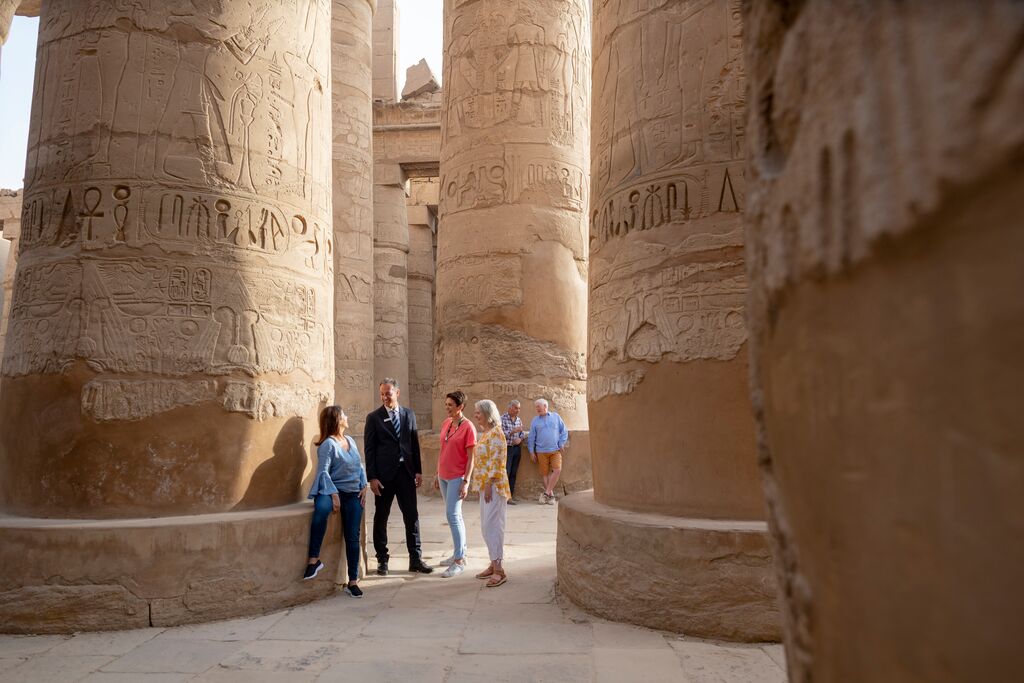 Luxury Gold Travel Concierge showing guests around the Luxor Temple