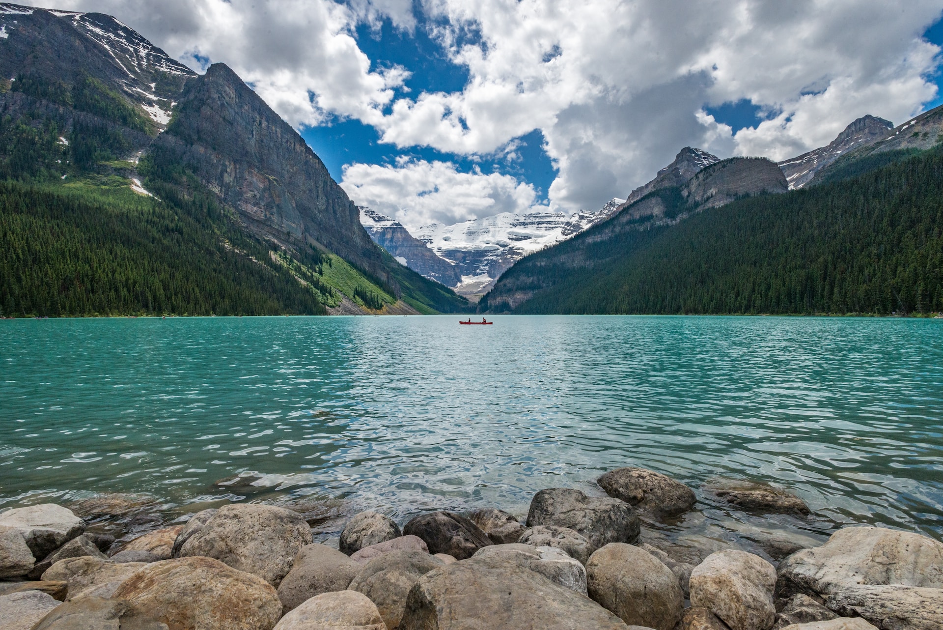 Image of Lake Louise, two people in a two-man kayak crossing in the distance