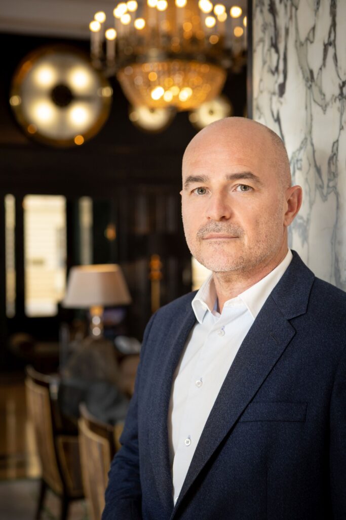 Hotel Esplanade Zagreb General Manager Ivica Krizmanic is pictured in a suit standing against the marbled walls of the hotel lobby