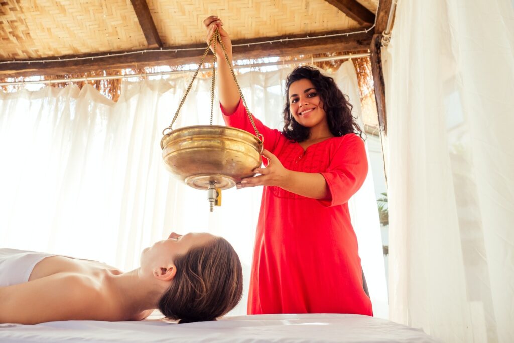 woman giving an ayurveda treatment