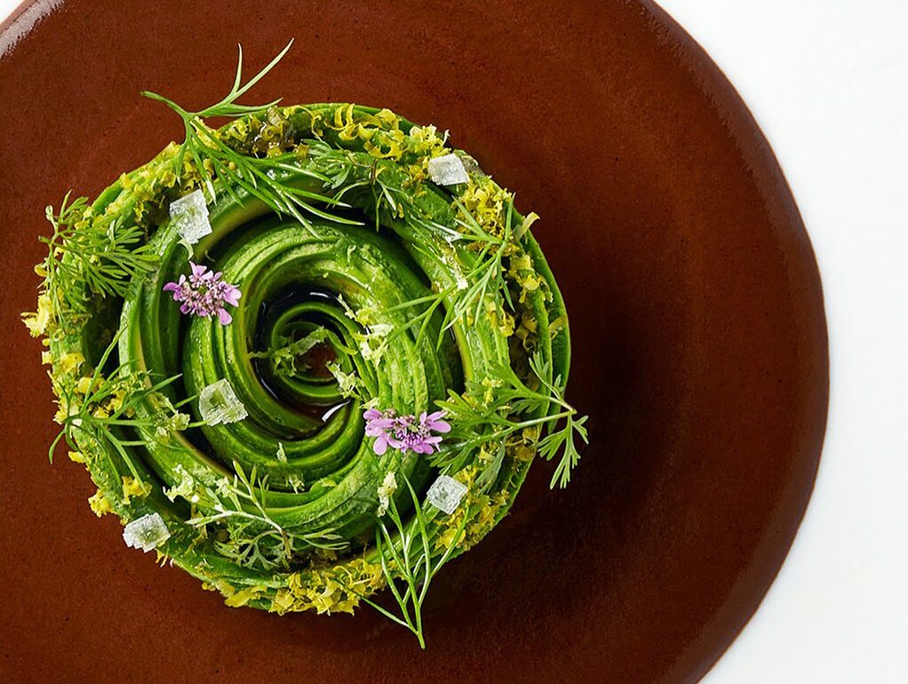 Birdseye view of plate of food on brown plate at COME restaurant