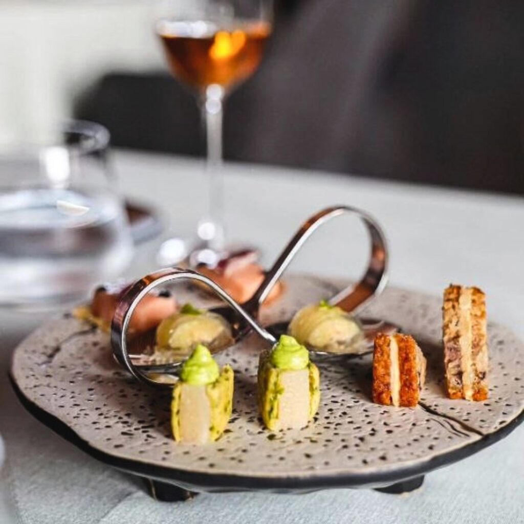 Close up of delicate plate of small morsels of colorful food