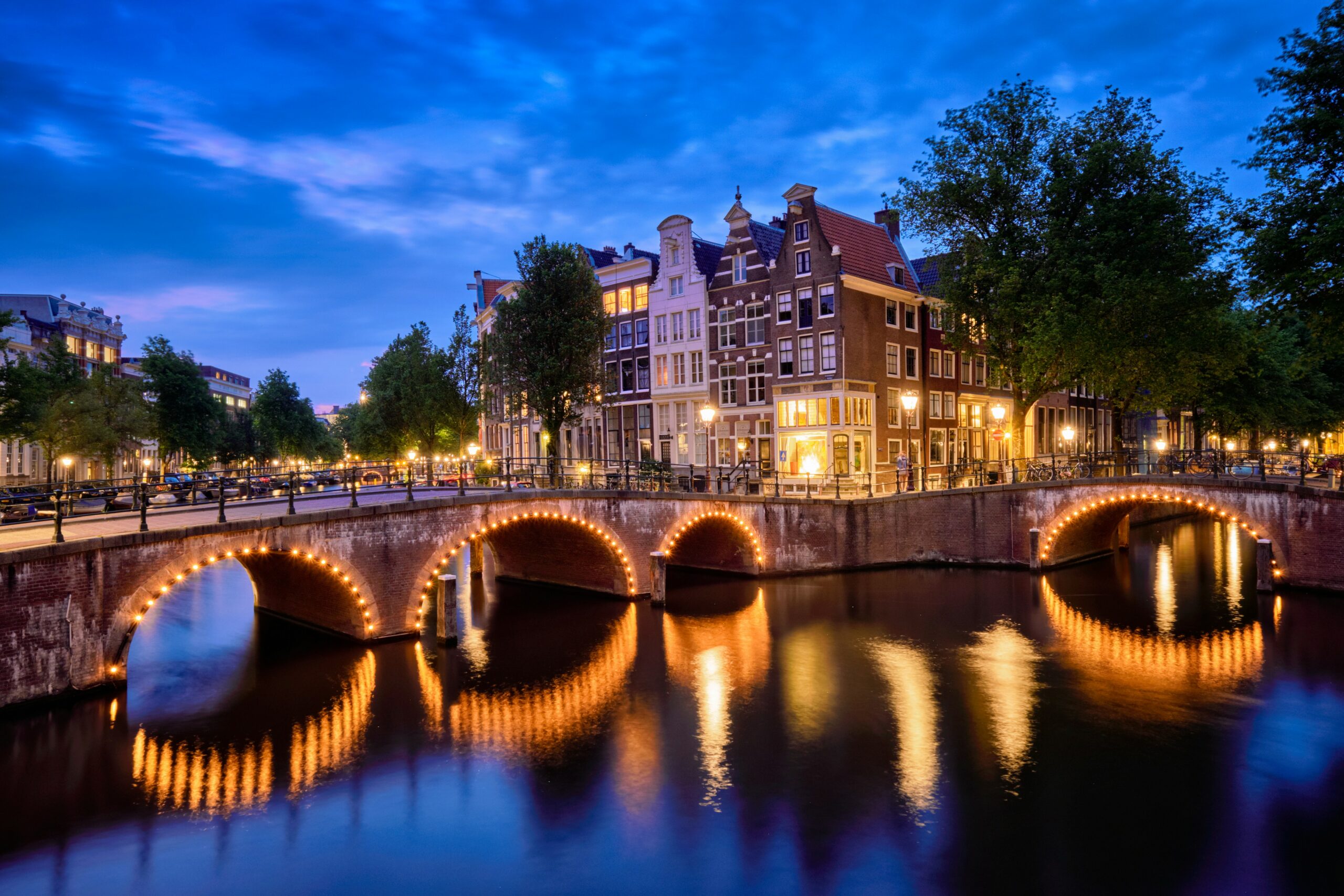 Amsterdam canal lit up at night