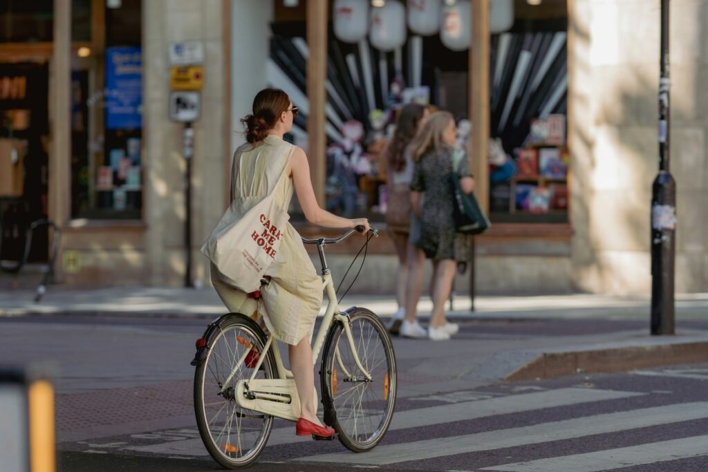 Women cycling on a vintage bicycle through London