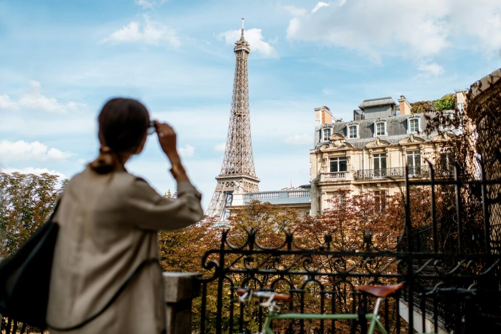 Woman in foreground looking towards Eiffel Tower 